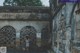 A woman standing in the middle of an old building.