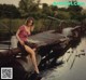 A woman sitting on a boat in the water.