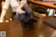 A woman sitting at a desk with her legs crossed.