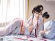 A woman in a white kimono laying on a bed.